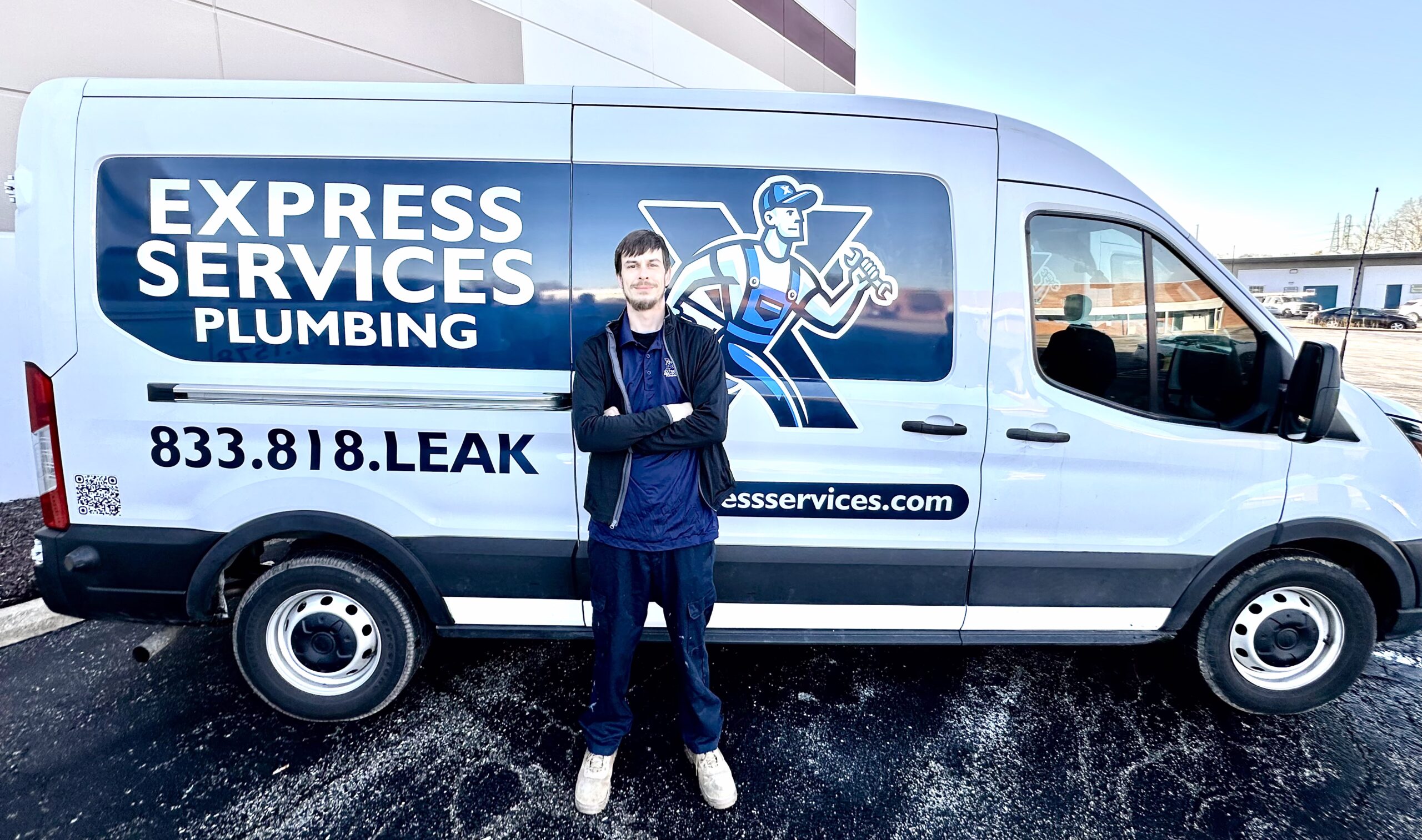 plumber next to a van from Express Services MEP